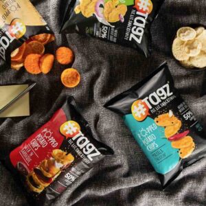 Packet of TagZ popped chips with a bowl of crispy, popped chips beside it, labeled “Not Fried” for a guilt-free snack vibe.