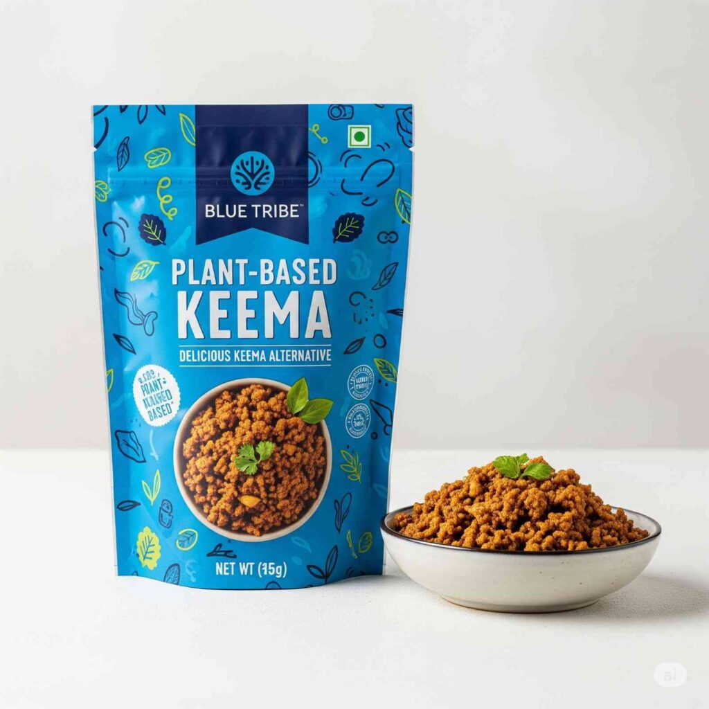 Pack of Blue Tribe’s Plant-Based Keema next to a bowl of cooked keema garnished with coriander, served with roti and lemon wedges